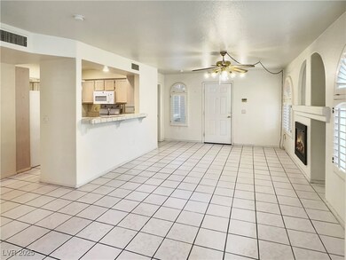Unfurnished living room featuring a ceiling fan, a