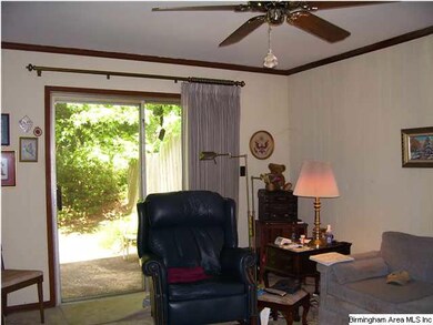 cozy den with sliding glass doors opening to priva