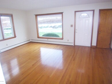 LR w wood floors& picture window