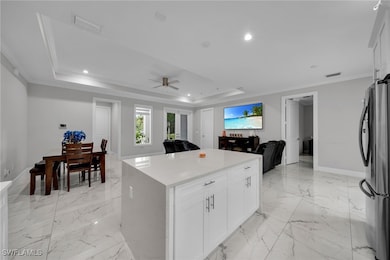 Kitchen featuring freestanding refrigerator, open