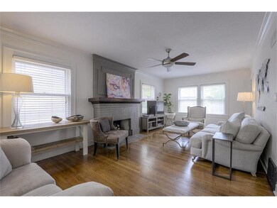 ENJOY GLEAMING HARDWOOD FLOORS IN A LIVING ROOM SURROUNDED WITH WINDOWS!