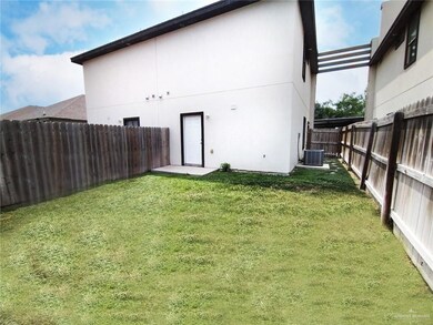 Back of house with a fenced backyard and stucco siding