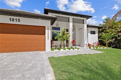 Contemporary home featuring stucco siding, drivewa