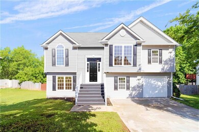 Bi-level home featuring driveway and a garage