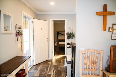 Corridor with dark hardwood / wood-style flooring
