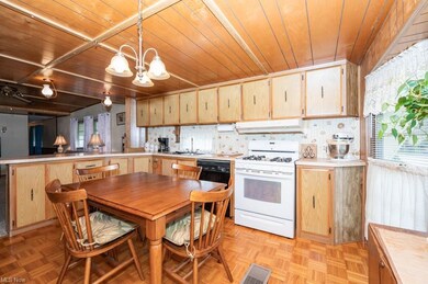 Kitchen featuring white gas range oven, wood ceili