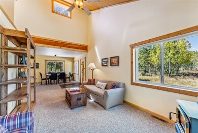 Living room with a towering ceiling, beamed ceilin