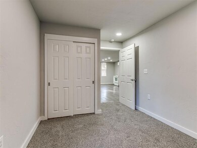 Unfurnished bedroom featuring light carpet, a closet, and recessed lighting