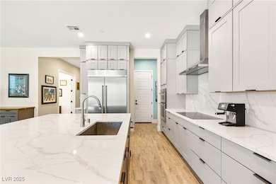 Kitchen with wall chimney exhaust hood, appliances