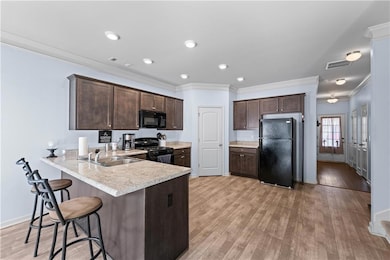 Kitchen with light wood finished floors, light cou