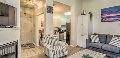 Living room featuring baseboards and light wood fi