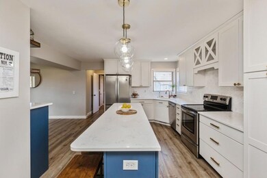 Gorgeous kitchen renovation!  White enameled cabinetry and quartz counters. (Even more beautiful (and spacious) in person!)