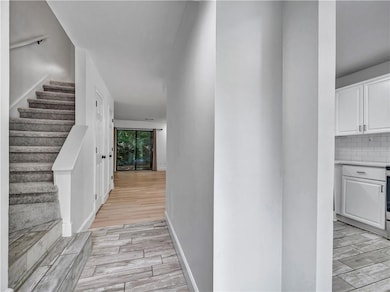 Hall with wood tiled floors and stairs