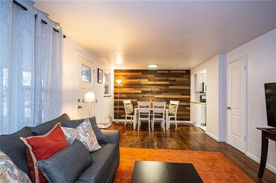 Open living and dining room with wood accent wall 