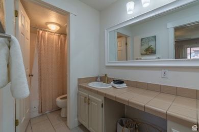 Bathroom featuring light tile patterned floors and vanity