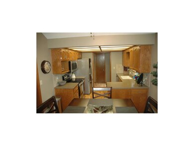 Spacious updated kitchen with solid surface counte