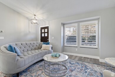 Living room with wood finished floors and a chandelier
