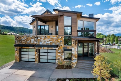 Contemporary home with a chimney, concrete drivewa