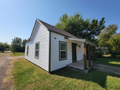 View of side of property with a lawn