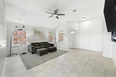 Living area featuring ceiling fan, light tile pat