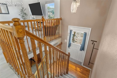 Staircase featuring wood finished floors and baseboards