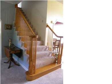 The pretty staircase to the upper floor and bedroo