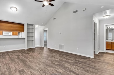Unfurnished living room with built in shelves, a c