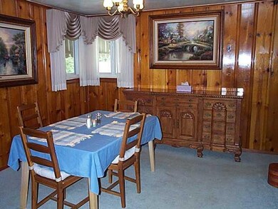 Dining Room. The dining room has knotty pine paneling and corner windows