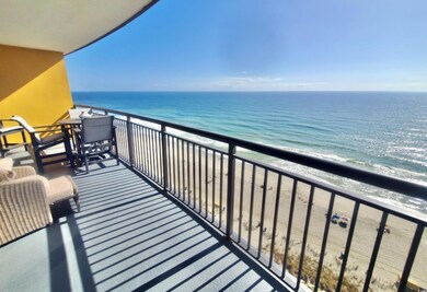 Balcony featuring a water view and a beach view