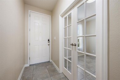 Doorway to outside with tile patterned flooring and french doors
