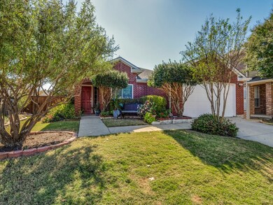 Obstructed view of property featuring brick siding, concrete driveway, and an attached garage