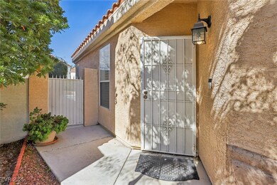 Entrance to property with a gate, a tile roof, and