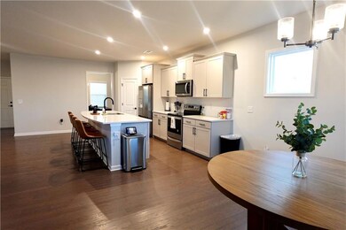 Kitchen with a center island with sink, a breakfas