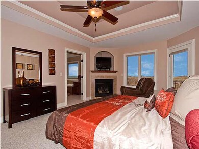 Master suite featuring a gas fireplace, serene lak