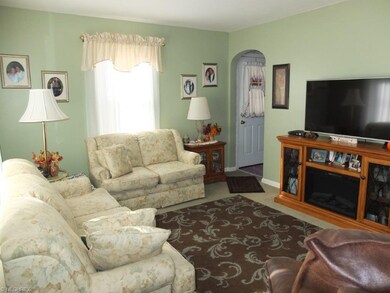 Living room with arched doorway.