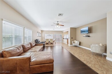 Living area featuring ceiling fan with notable cha