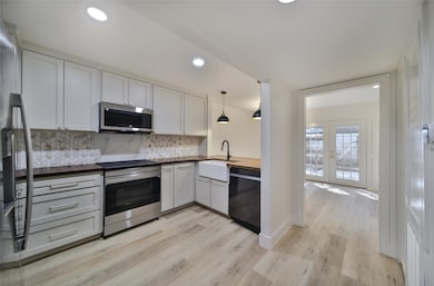 Kitchen with new stainless steel appliances.