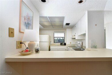 Kitchen with white cabinets, white appliances, kit