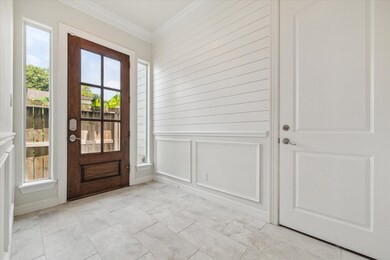 The foyer is both stylish and welcoming. An art ni