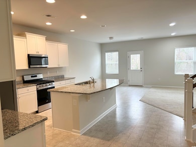 Kitchen featuring visible vents, a sink, stainless