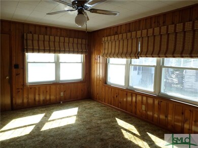 Family room with carpet, ceiling fan, and knotty p