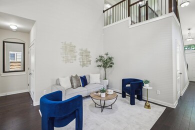Living room with a towering ceiling, baseboards, 