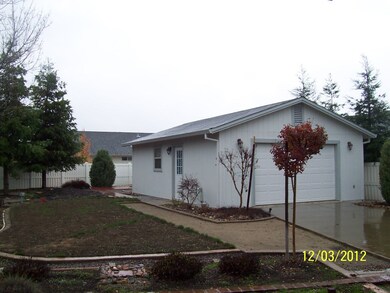 Detached garage with doors at both ends.