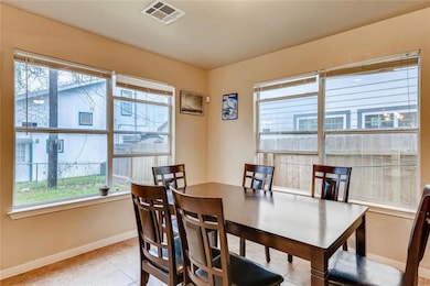 Dining space featuring baseboards, visible vents,