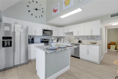 Kitchen with white cabinets and appliances with st