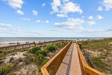 View of home's community with view of water and beach