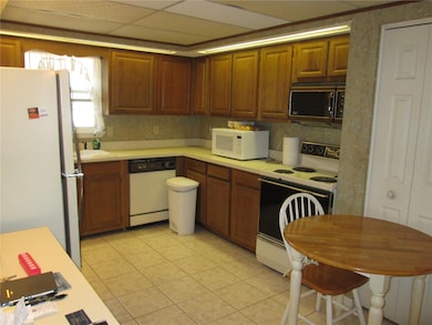 Tiled kitchen, dishwasher, range and micro.
