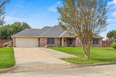 View of front of property with a concrete driveway, and an attached garage