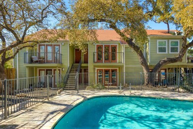 Rear view of house with a balcony, fence, french 