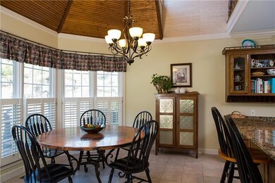 Enjoy the sunlight from a beautiful bank of windows around the kitchen eating area, with this incredible ceiling. You feel like you are in a castle!